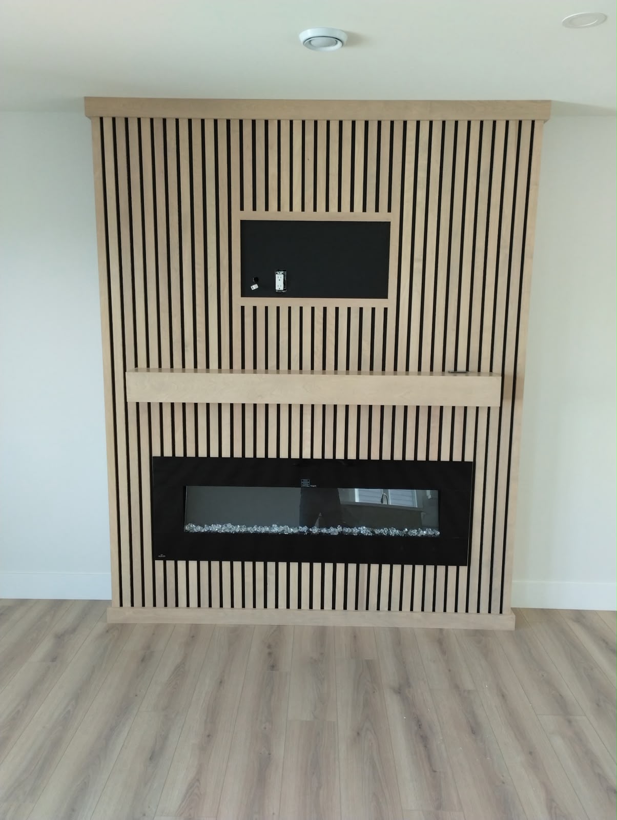 Custom wood slat fireplace and mantle by StairTrim Design
